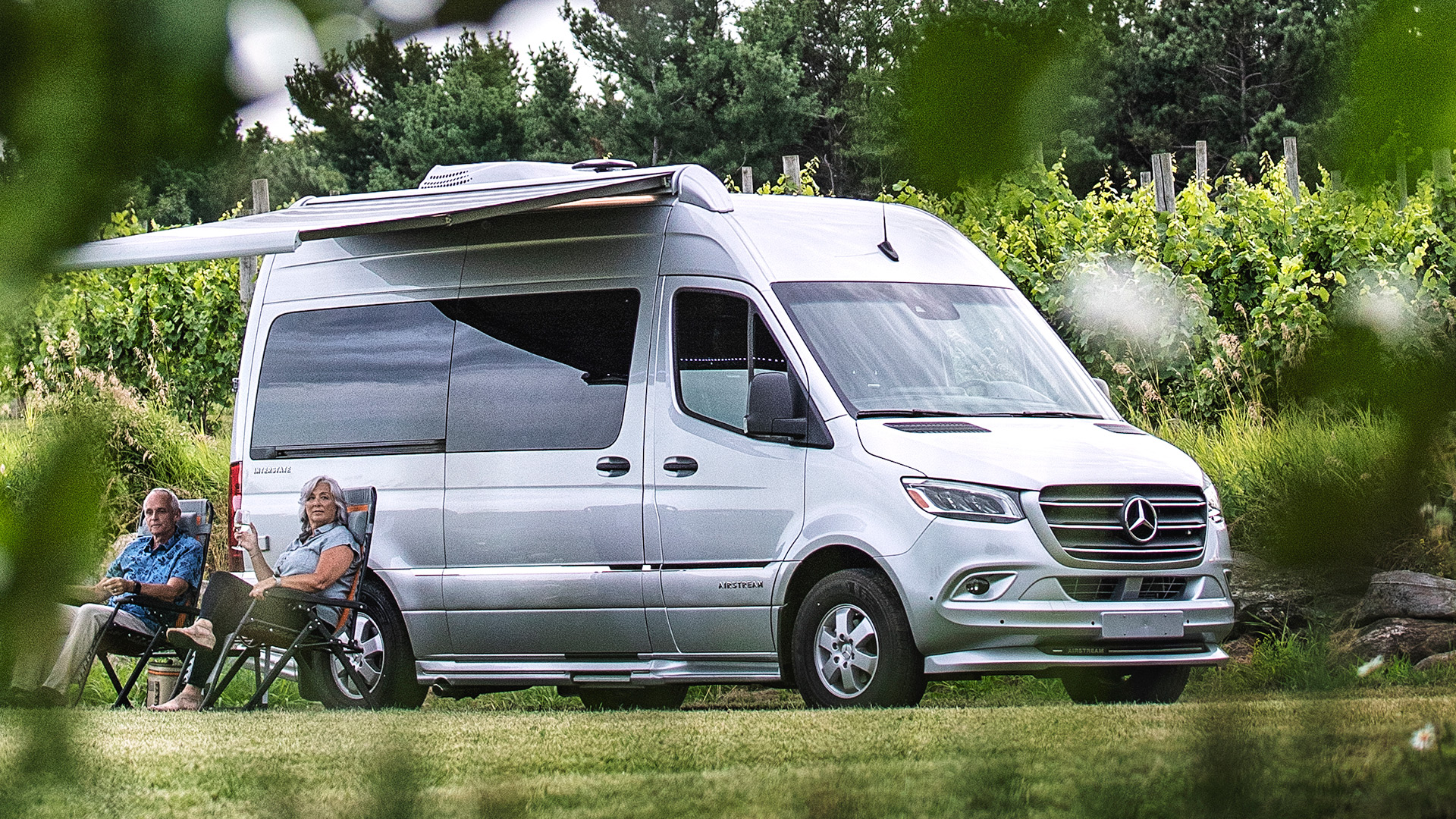 Airstream-Interstate-Nineteen-Couple-Sitting-Foliage-Gallery.jpg